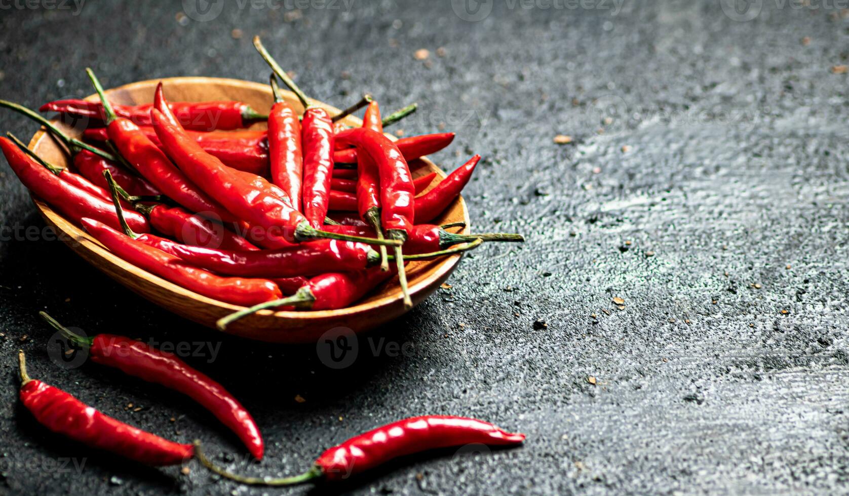 Chili peppers on a wooden plate. photo