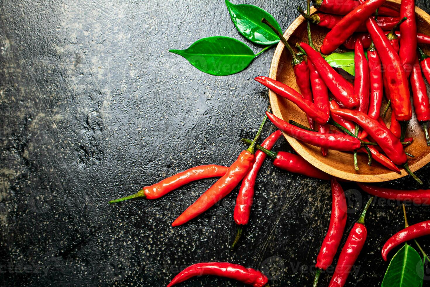 Chili peppers on a wooden plate. photo