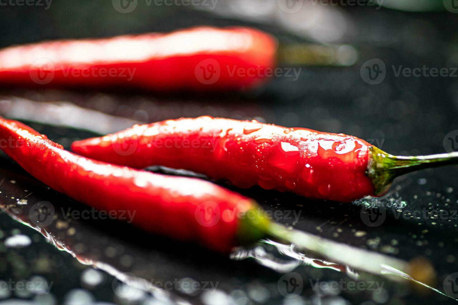 Pods of hot chili peppers on the table. photo
