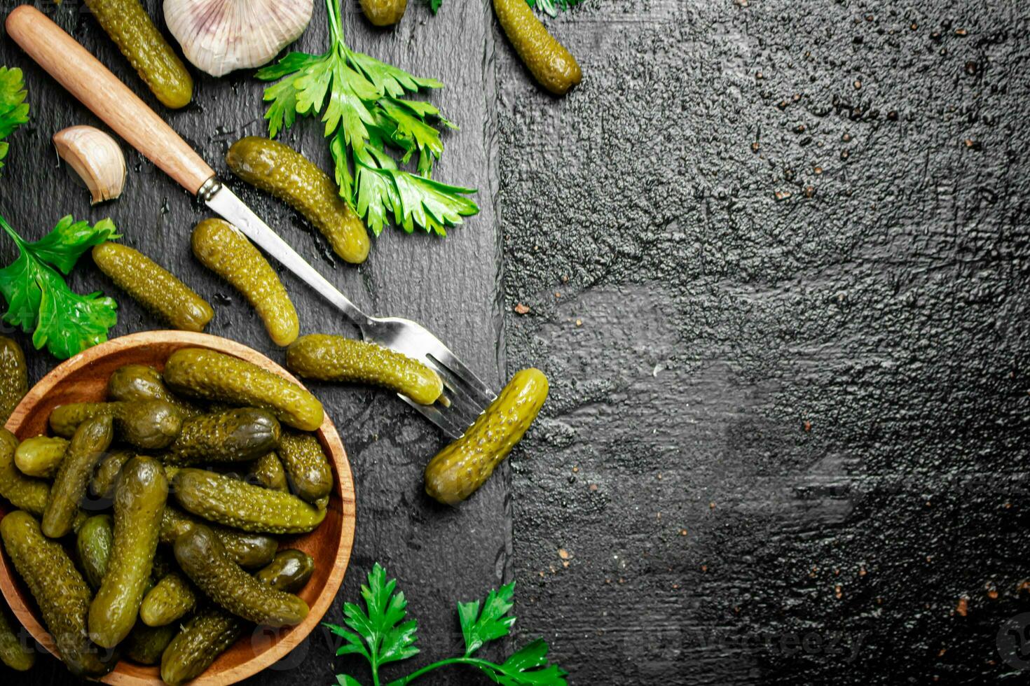 Delicious pickles cooked at home. On a black background. photo
