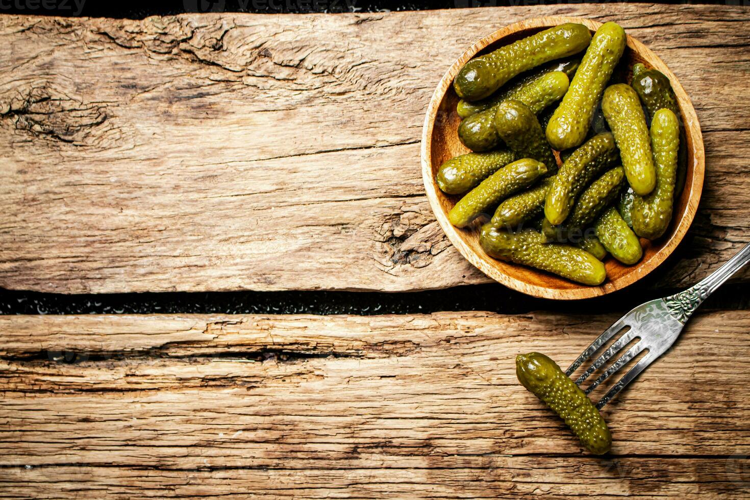 Pickled cucumbers on a wooden plate. photo