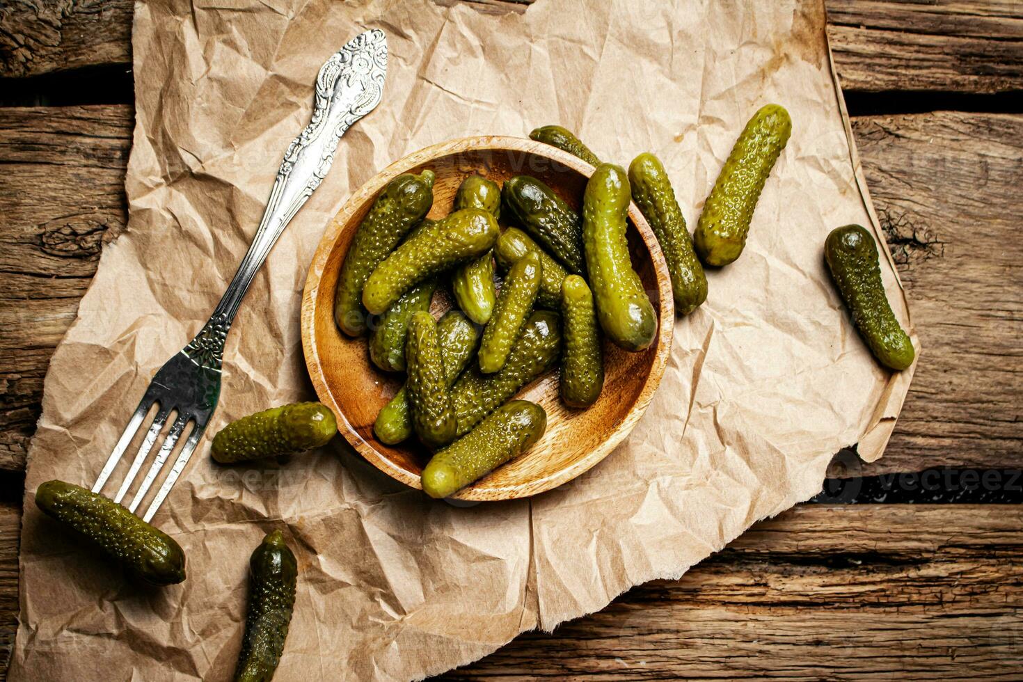 Pickled cucumbers on a wooden plate. photo