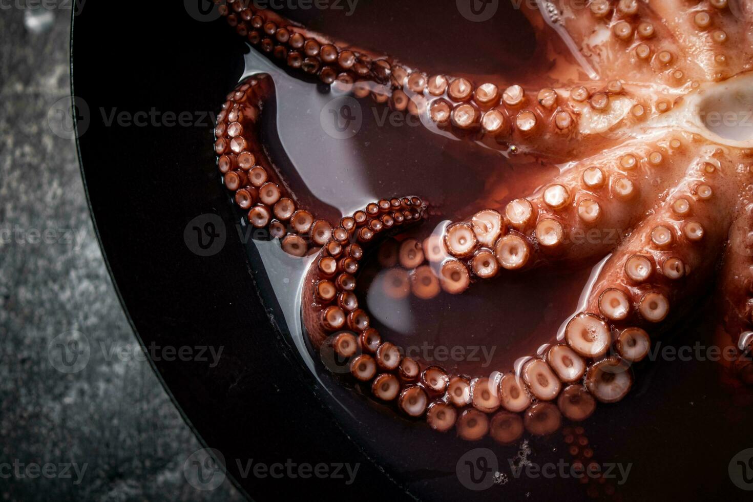 Octopus is boiled in a pot of water. photo