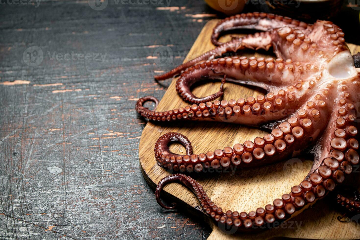 Octopus on a wooden cutting board. photo