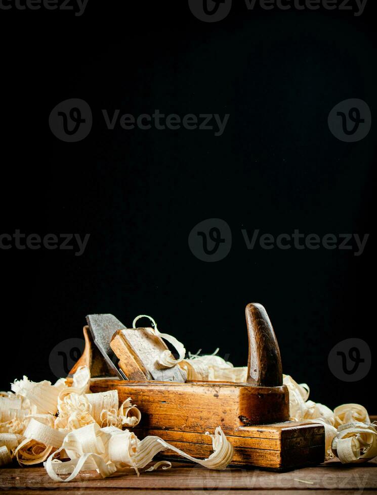 Hand planer on wood. On a black background. photo