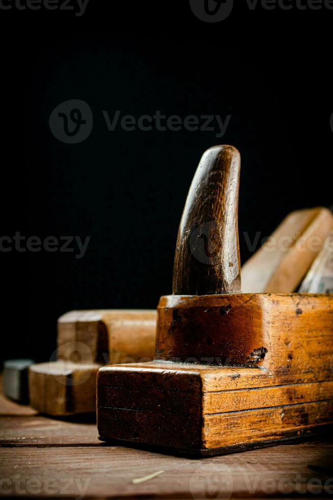 Hand planer on wood. On a black background. photo