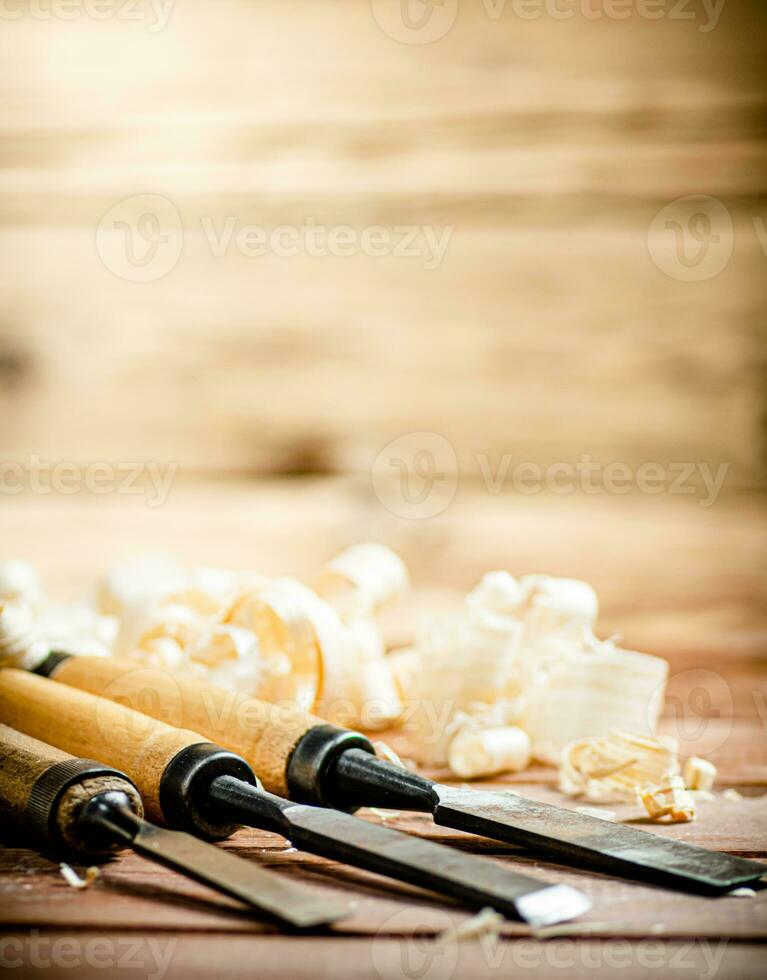 Chisel with a bunch of wood sawdust. photo