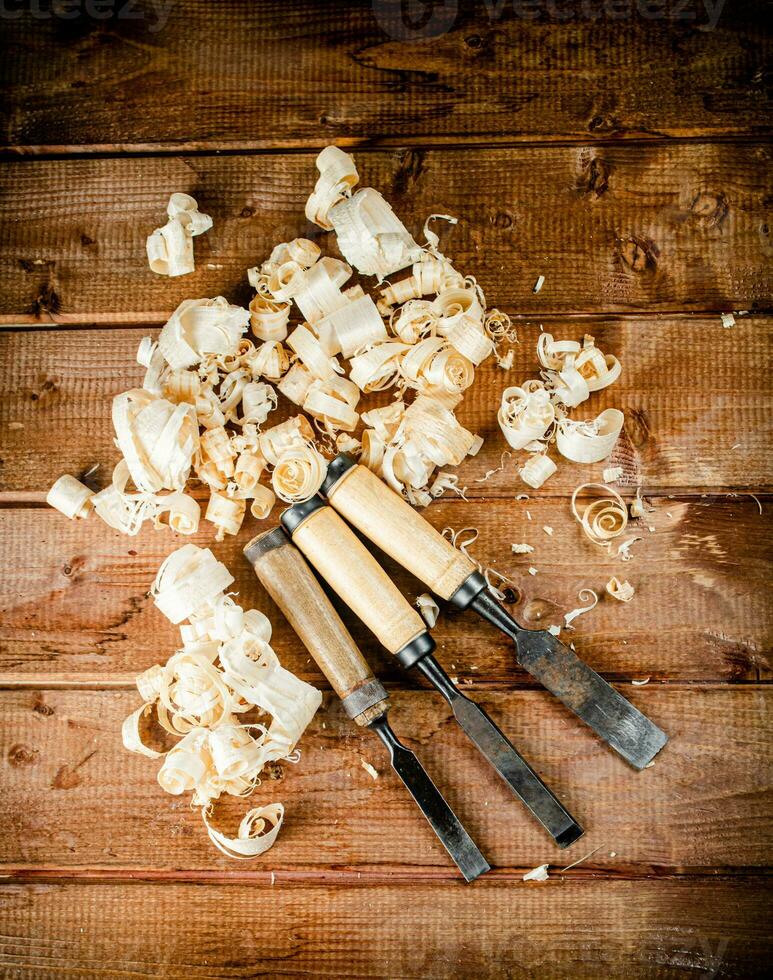 Chisel with a bunch of wood sawdust. photo