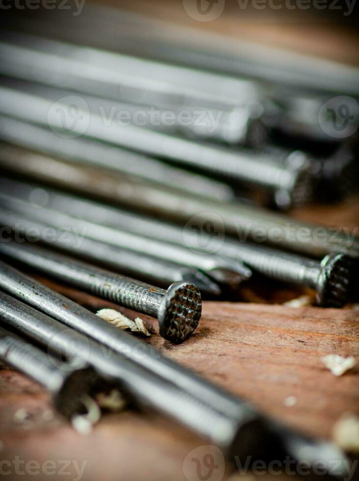 A bunch of nails on the table. photo