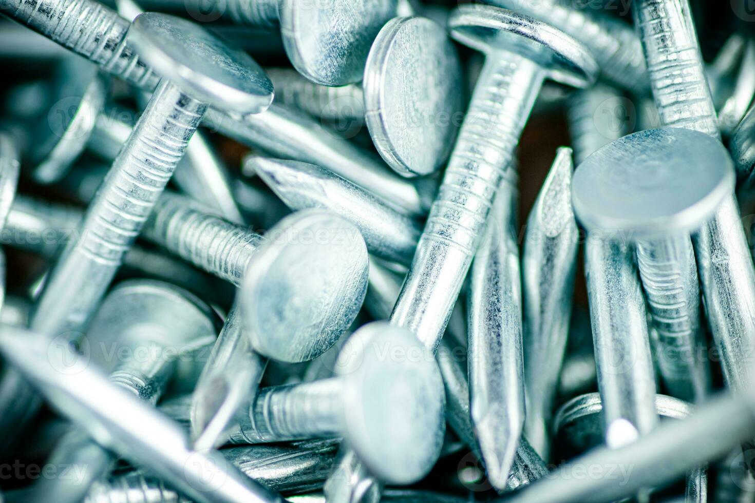 A pile of roofing nails. Macro background. photo