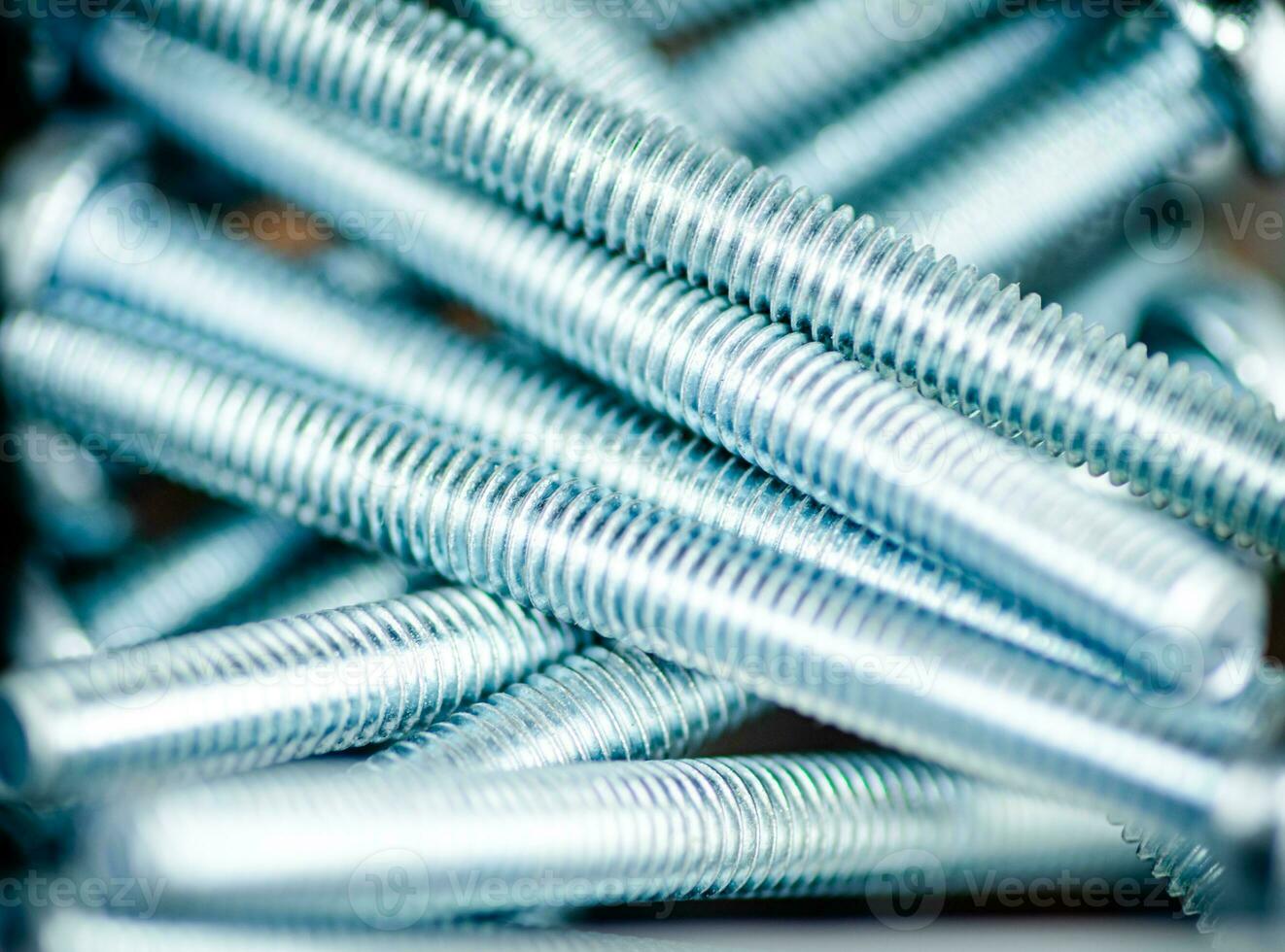 A pile of bolts. Macro background. photo
