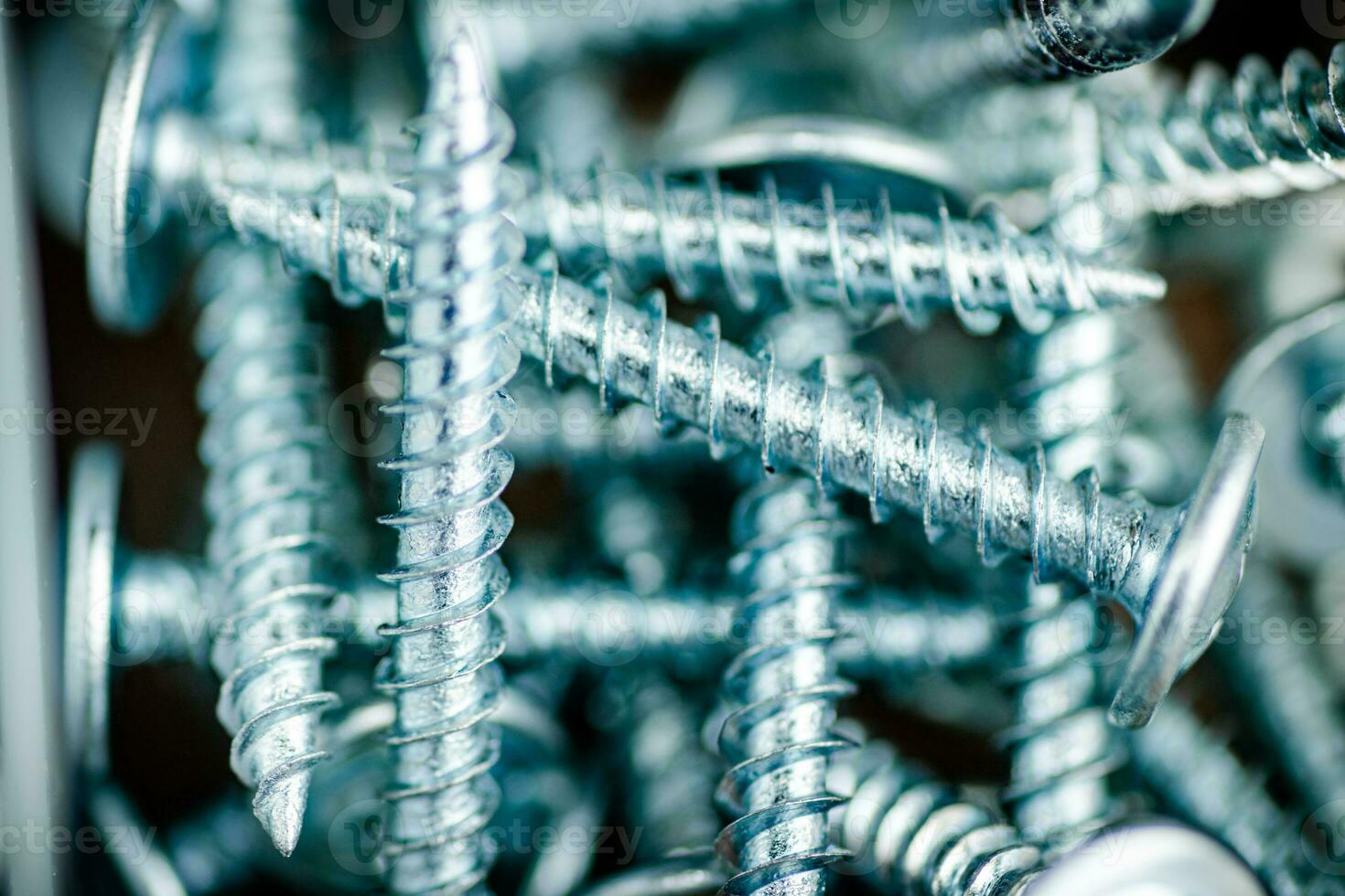 A pile of bolts. Macro background. photo