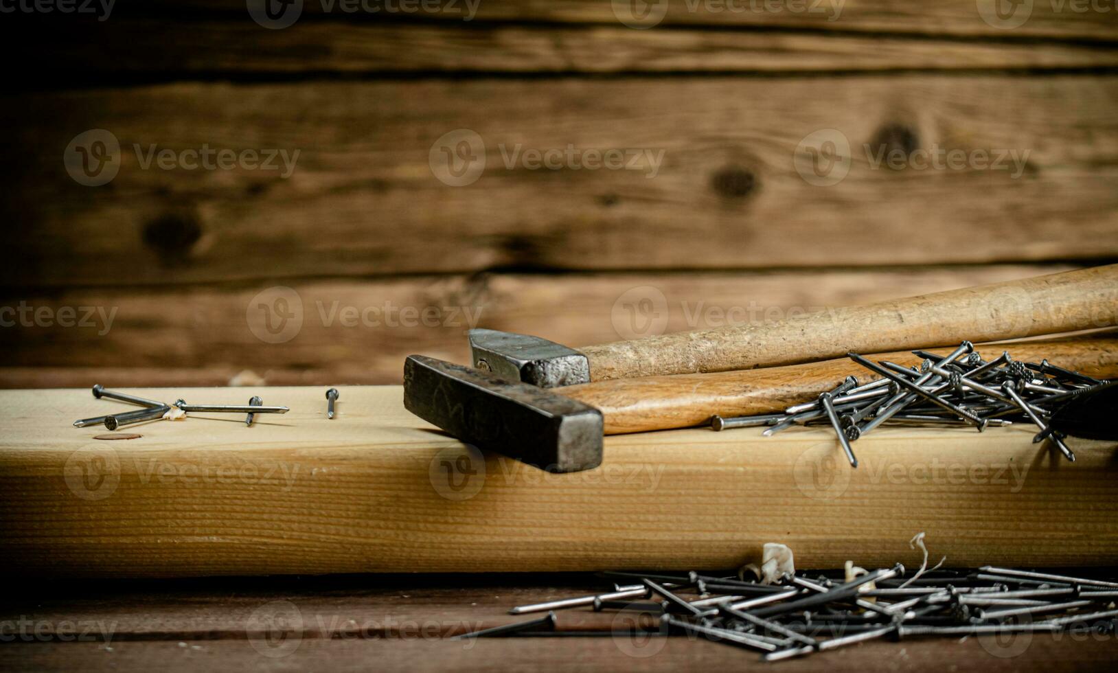 Hammer with a bunch of nails on the table. photo