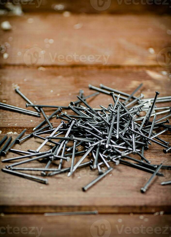 A pile of nails on the table. photo