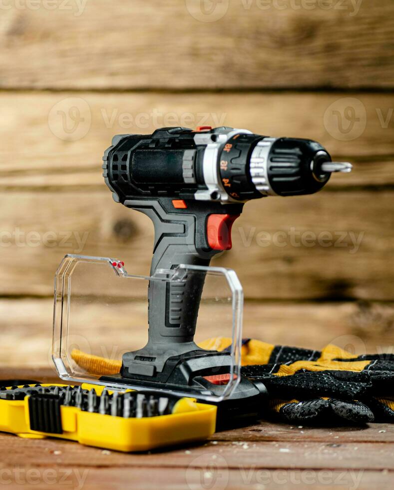 Working tools. Screwdriver bits. On a wooden background. photo
