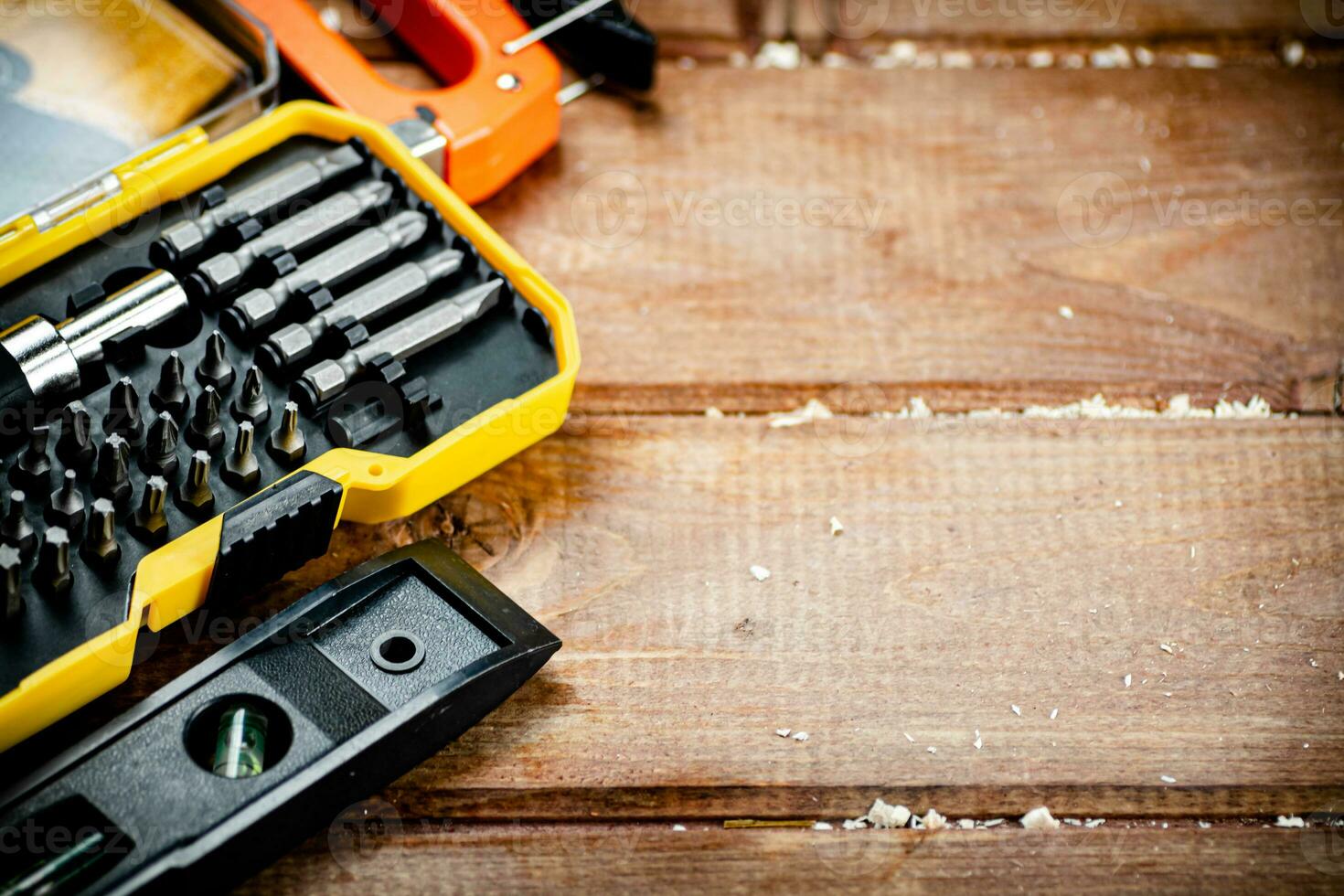 Working tools. Screwdriver bits. On a wooden background. photo