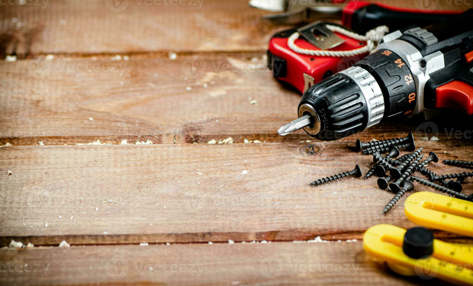 Working tool. Screwdriver with self-tapping screws on the table. photo