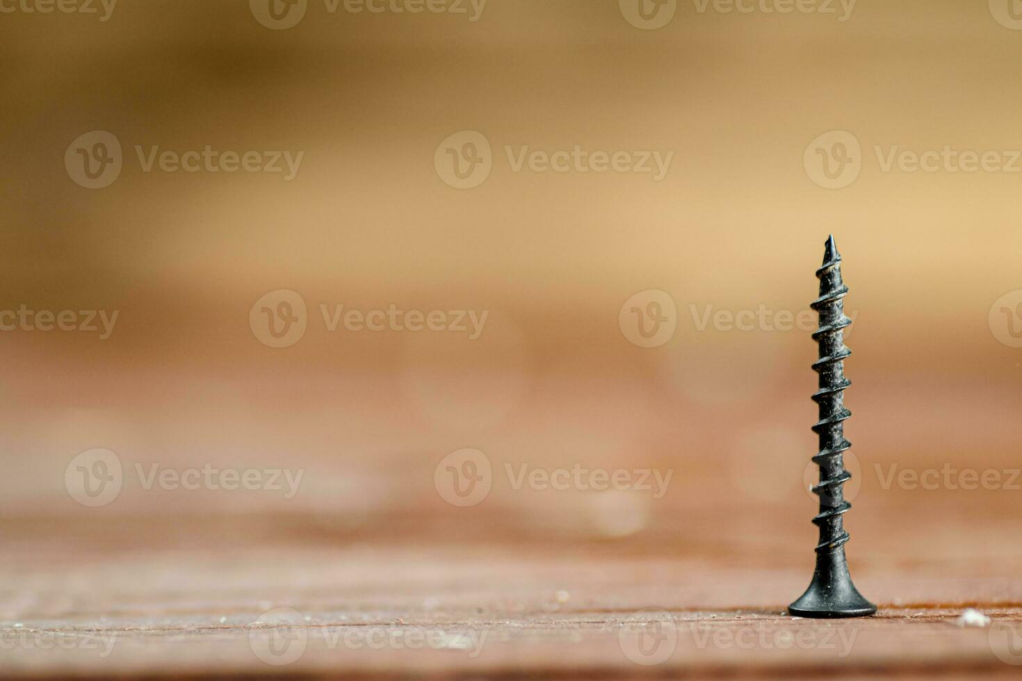 Self-tapping screw on wood on the table. photo