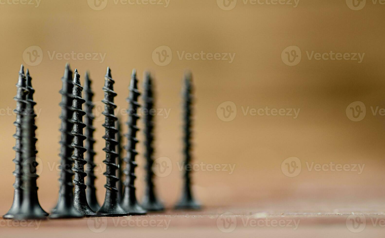 Self-tapping screw on wood on the table. photo