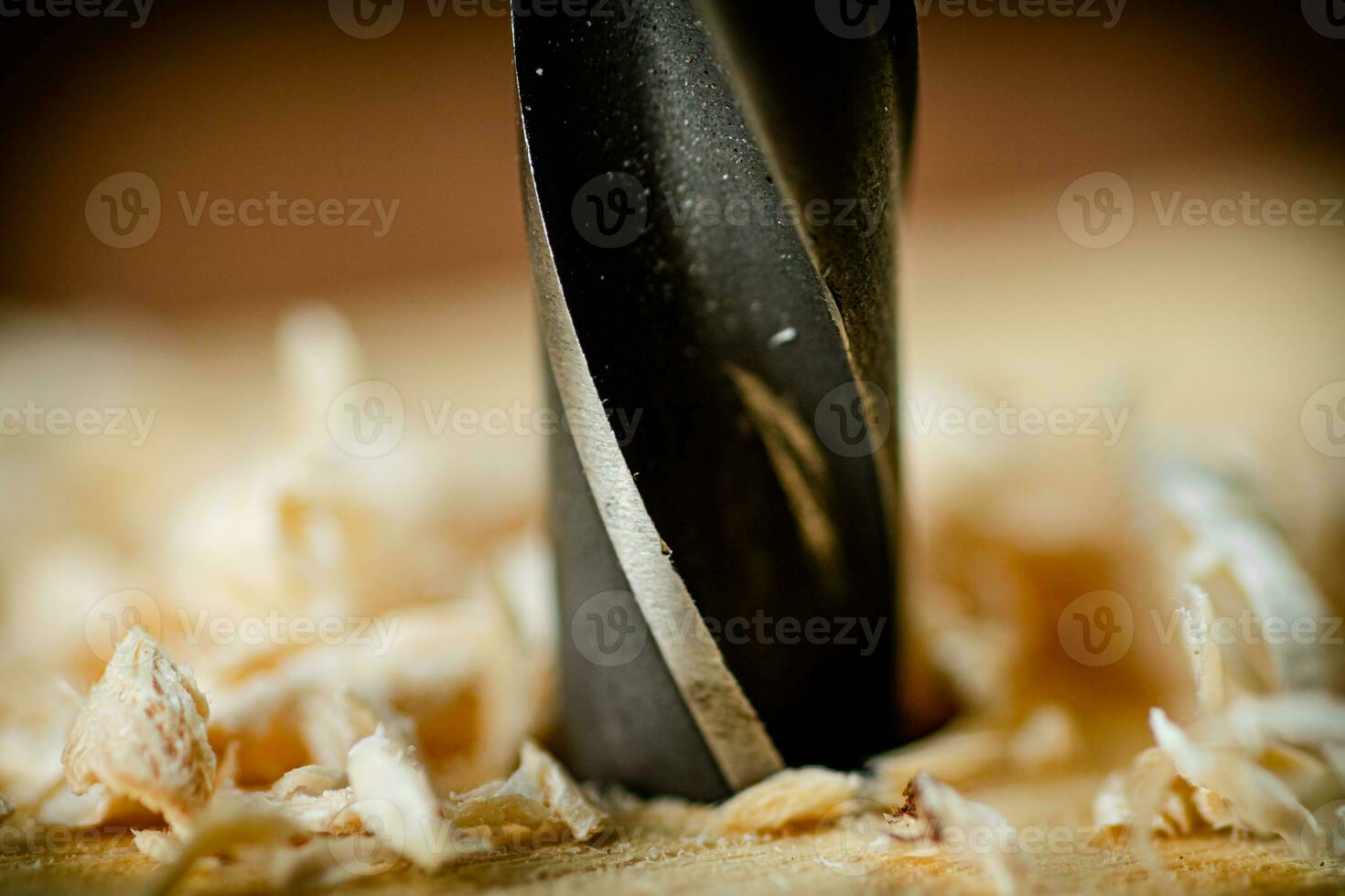Piece of wood is drilled with shavings. photo