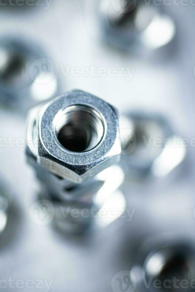 Working tool. Metal nuts on the table. photo