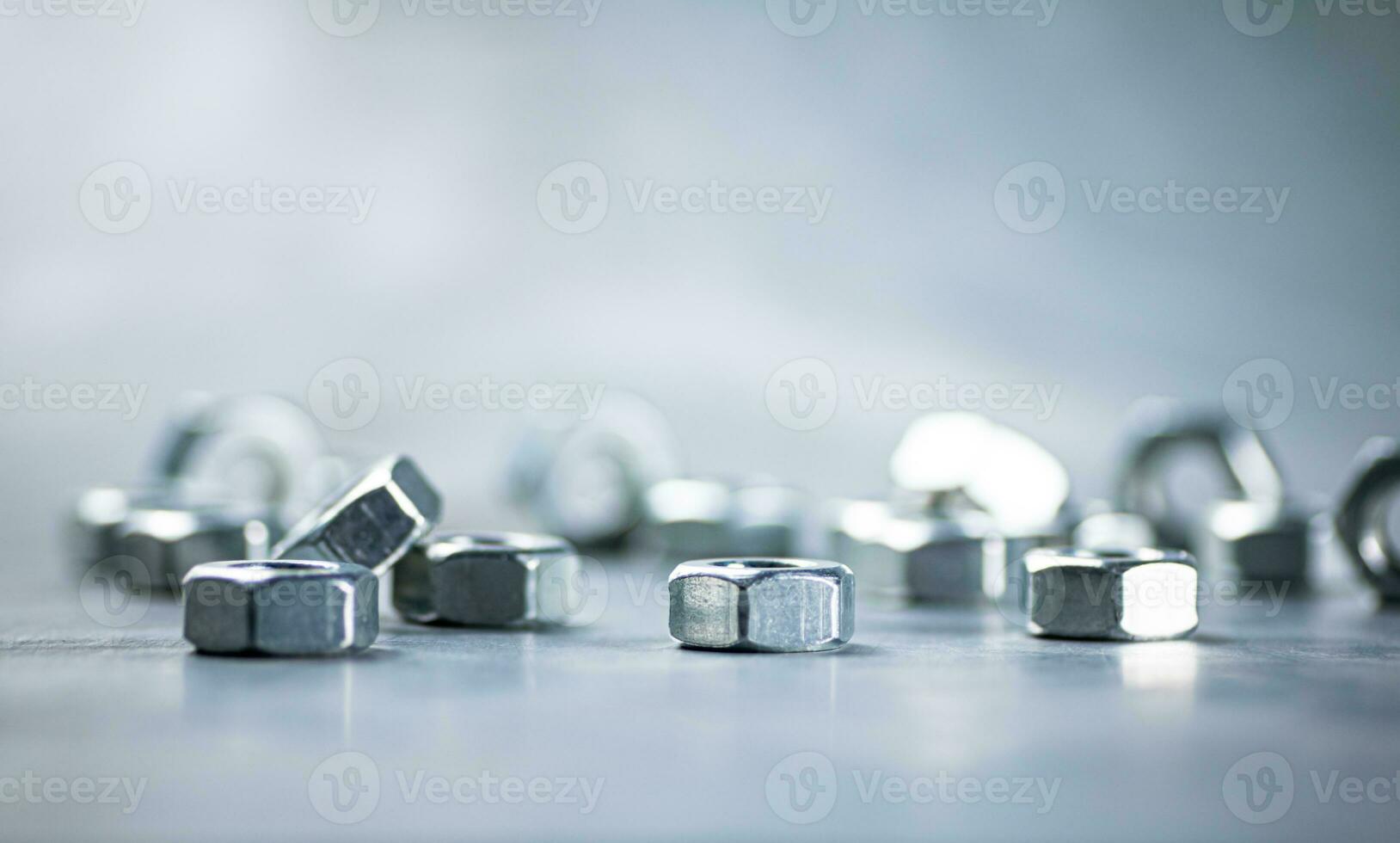 Working tool. Metal nuts on the table. photo