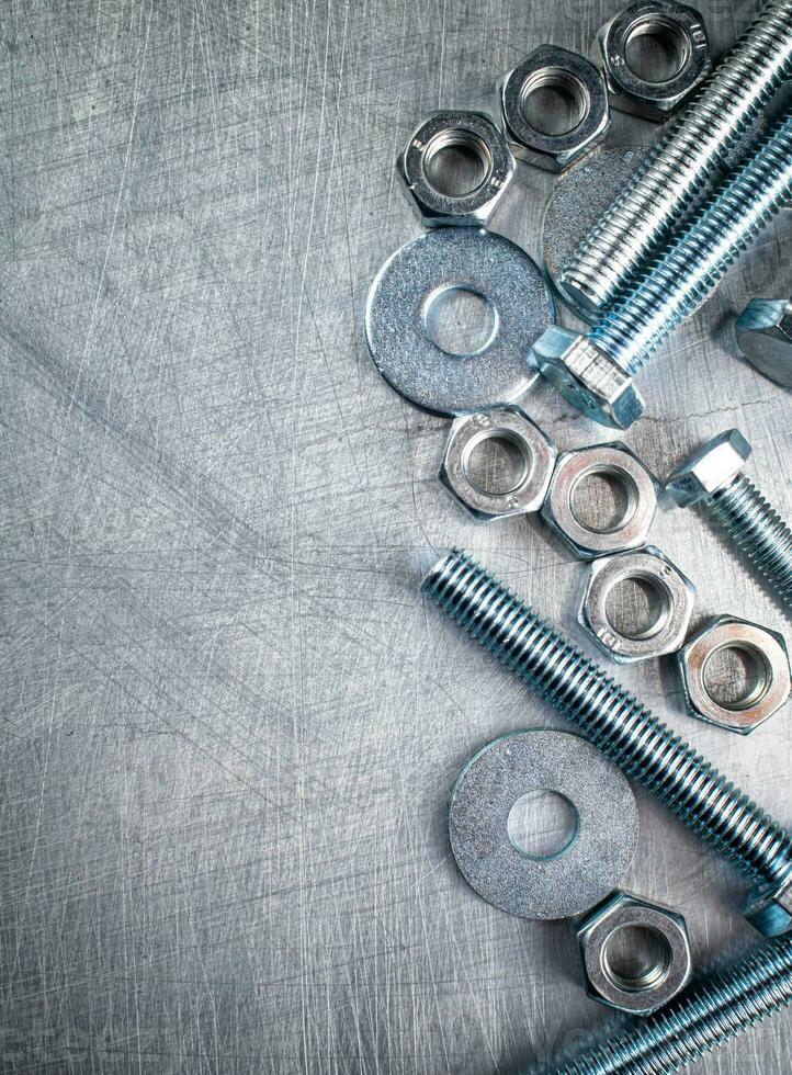 Working tool. Nuts and bolts on the table. photo
