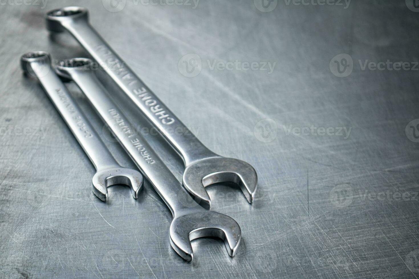 Metal wrench on the table. photo