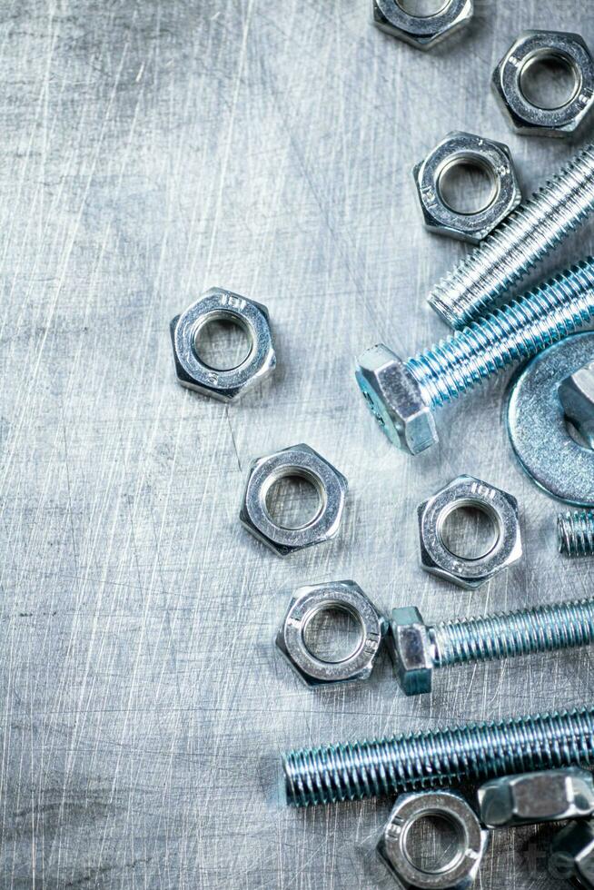 Working tool. Nuts and bolts on the table. photo