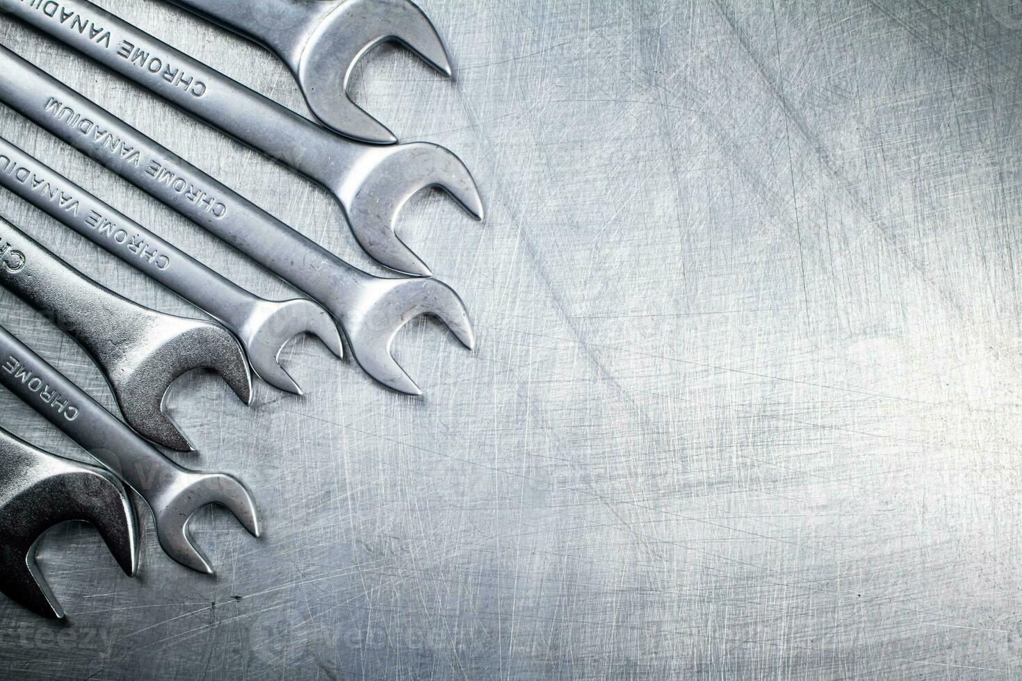 Metal wrench on the table. photo