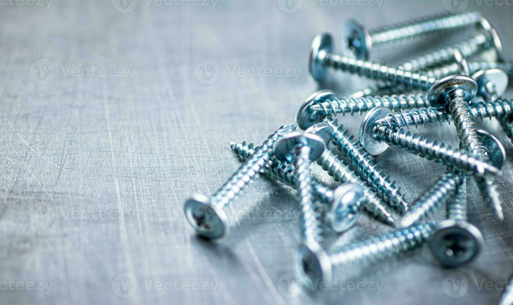 A bunch of self-tapping screws on the table. photo