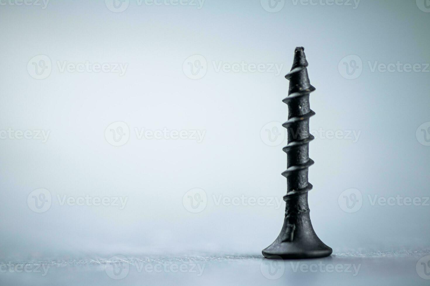 A bunch of self-tapping screws on the table. photo