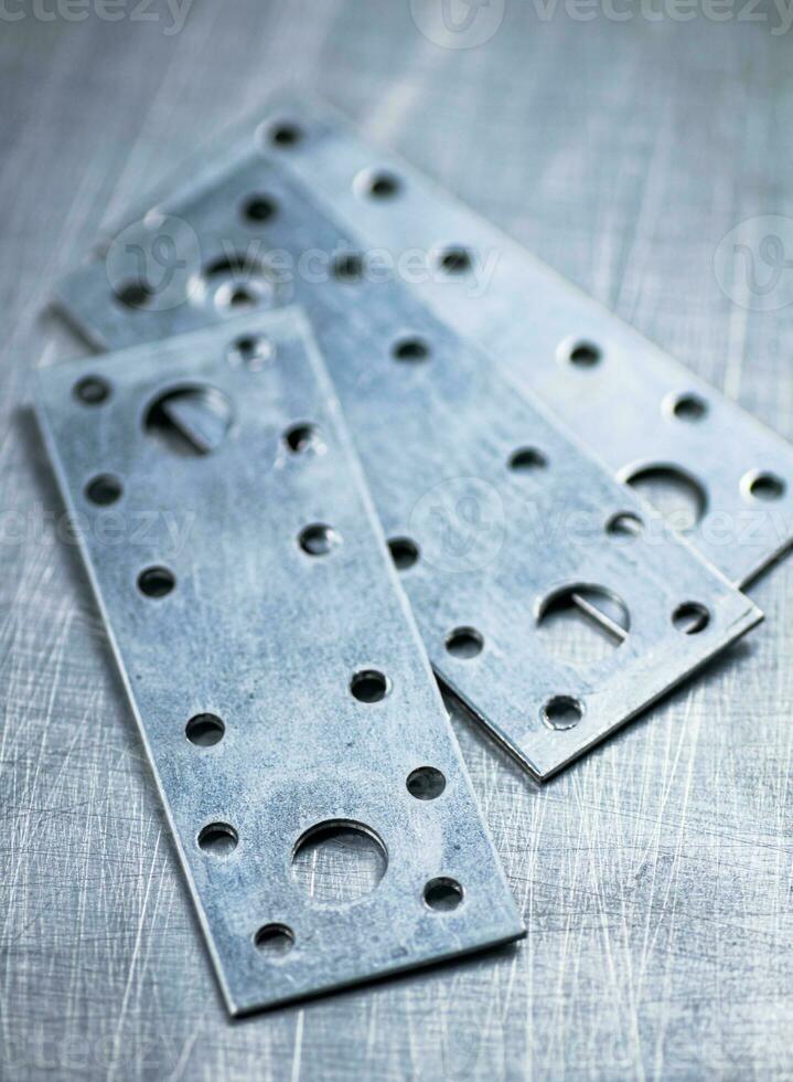 Metal plates for fastening wood. photo