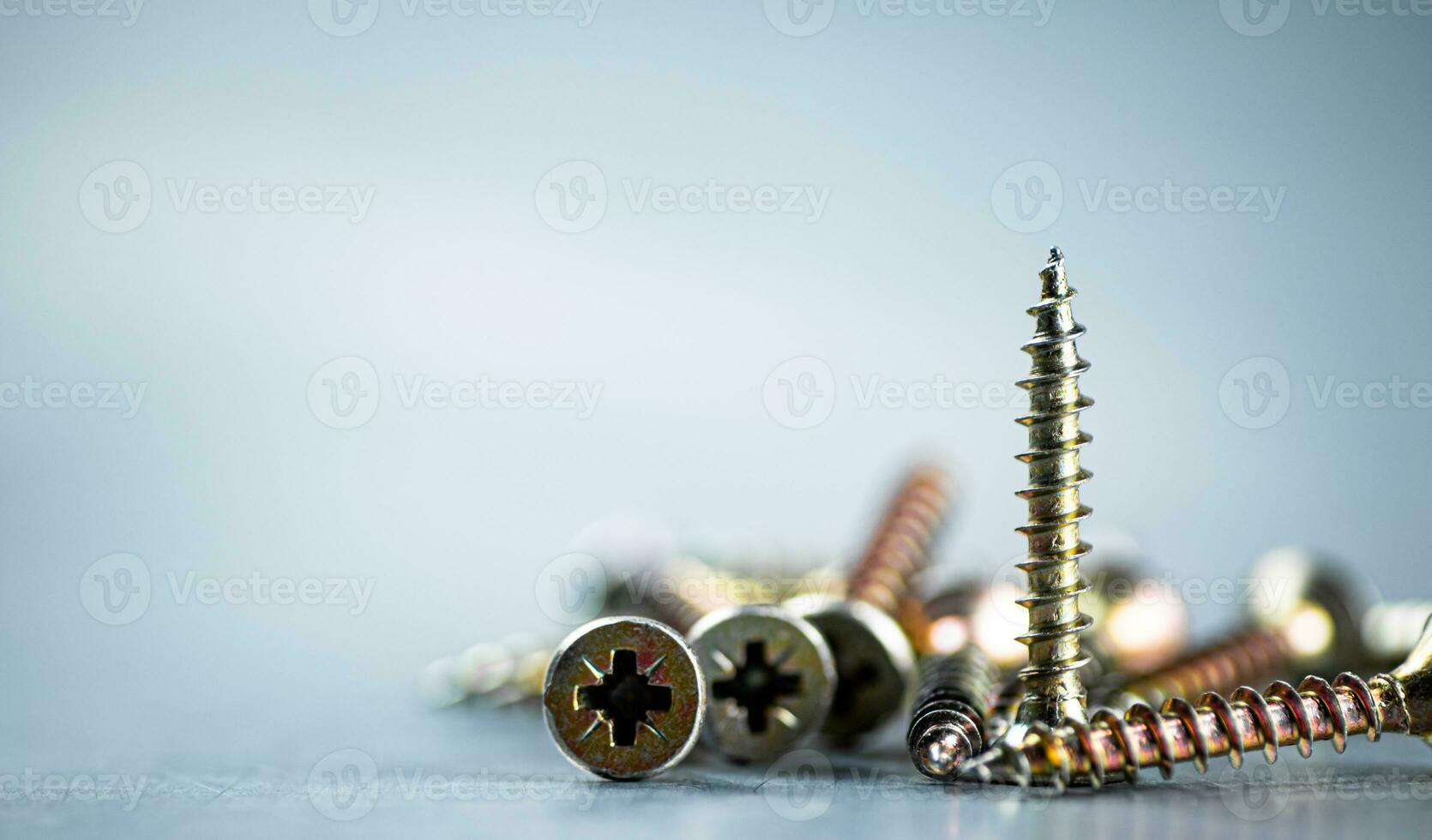 A bunch of self-tapping screws on the table. photo