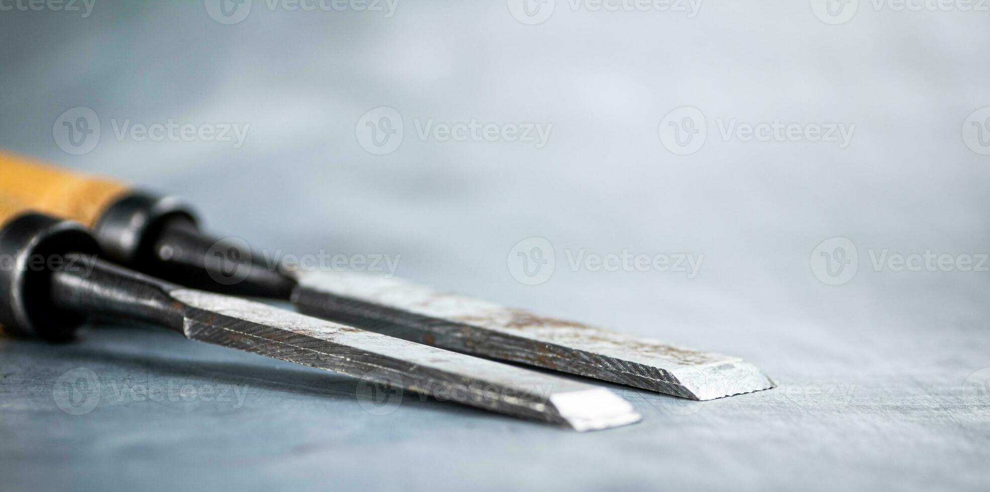 Chisel on wood on the table. photo