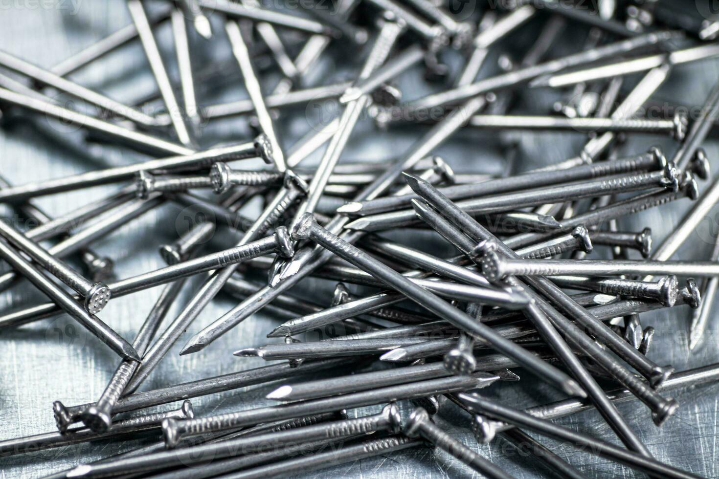 A bunch of nails on the table. photo