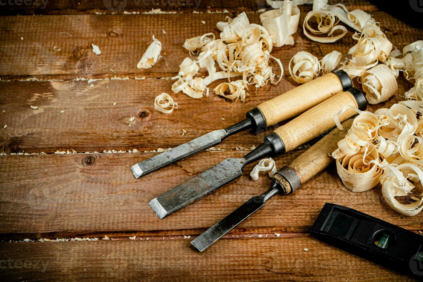 Chisels with wooden sawdust on the table. photo