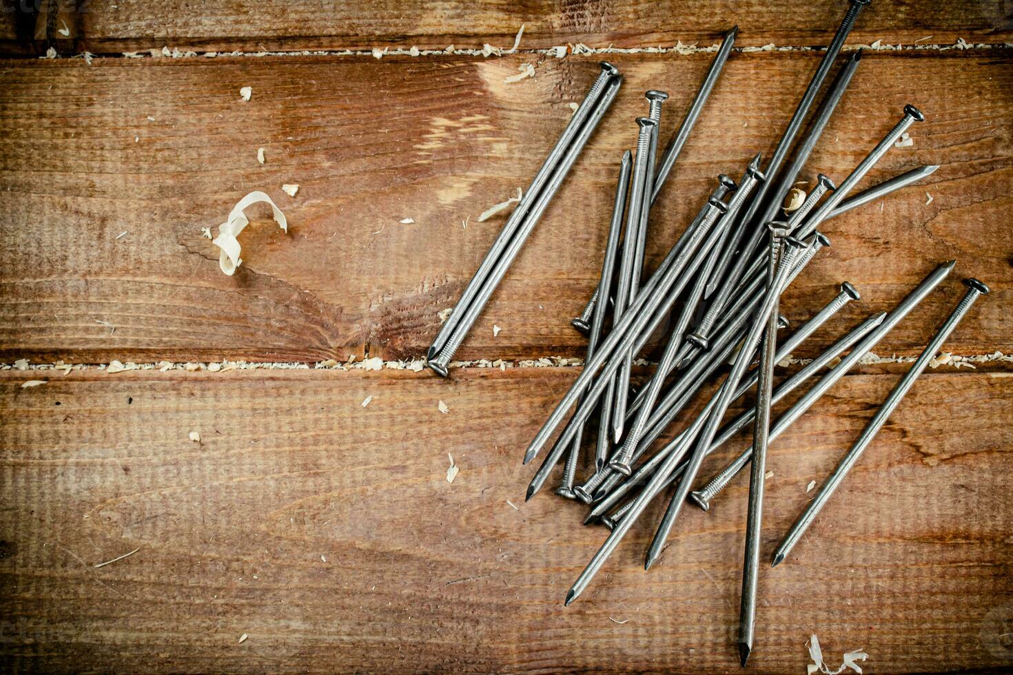 Nails on the table. On a wooden background. photo