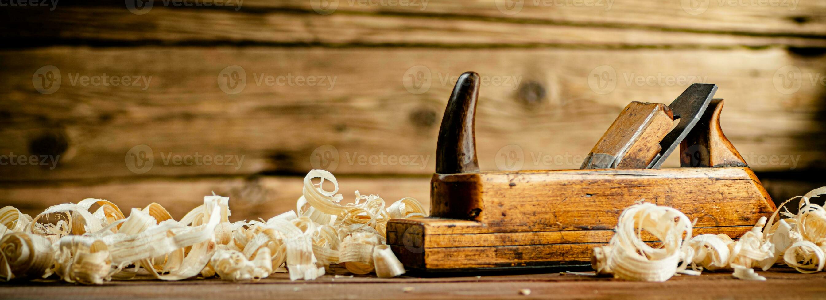 A planer with wooden shavings on the table. photo