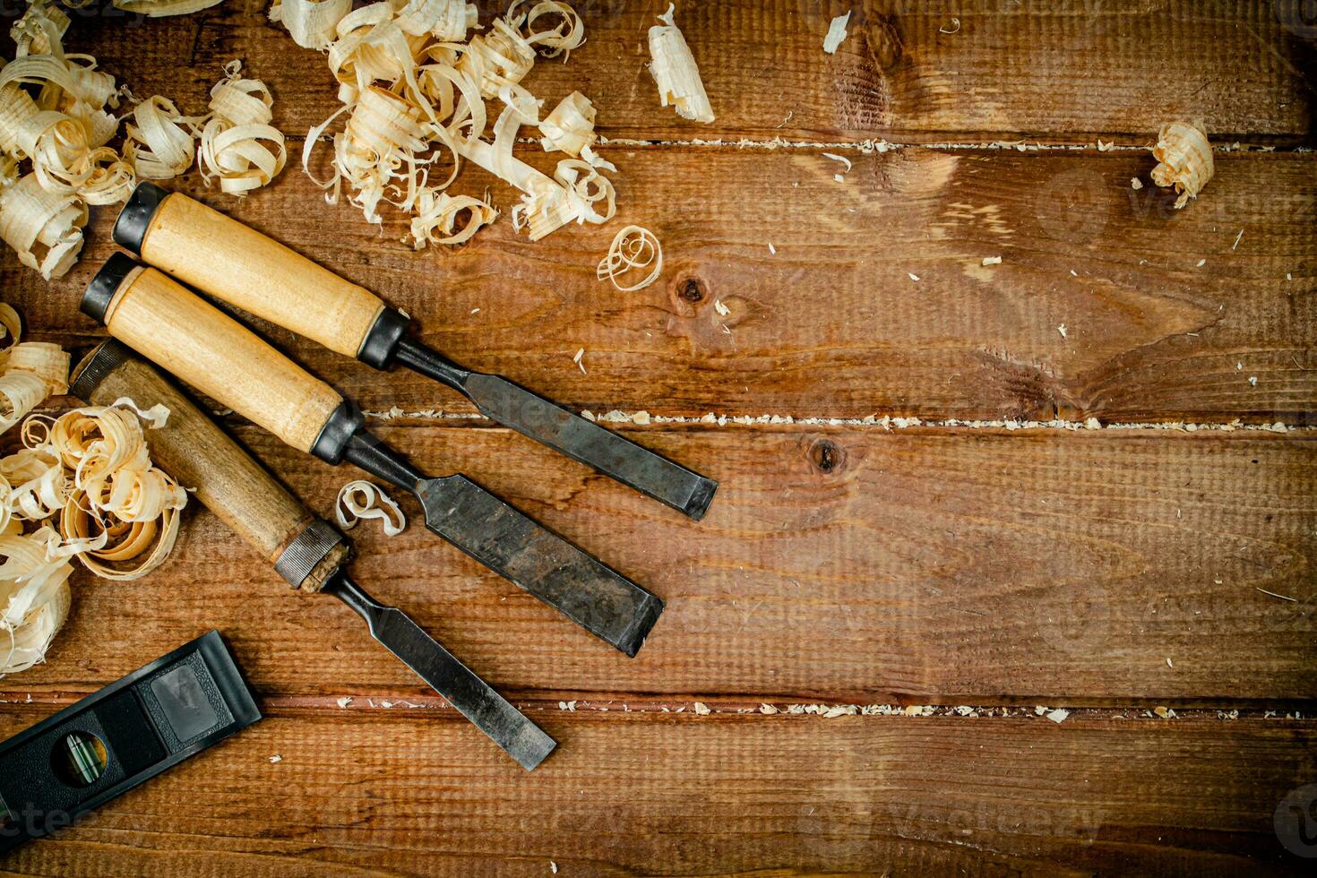 Chisels with wooden sawdust on the table. photo