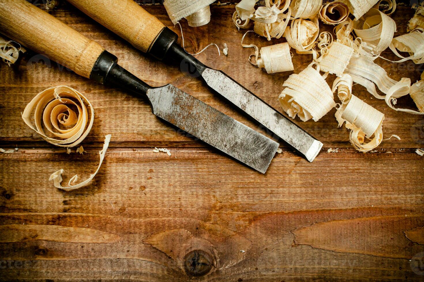 Chisels with wood chips on the table. photo