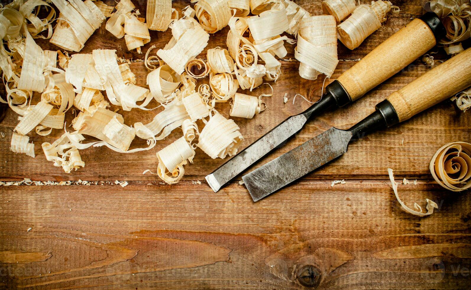 Chisels with wood chips on the table. photo