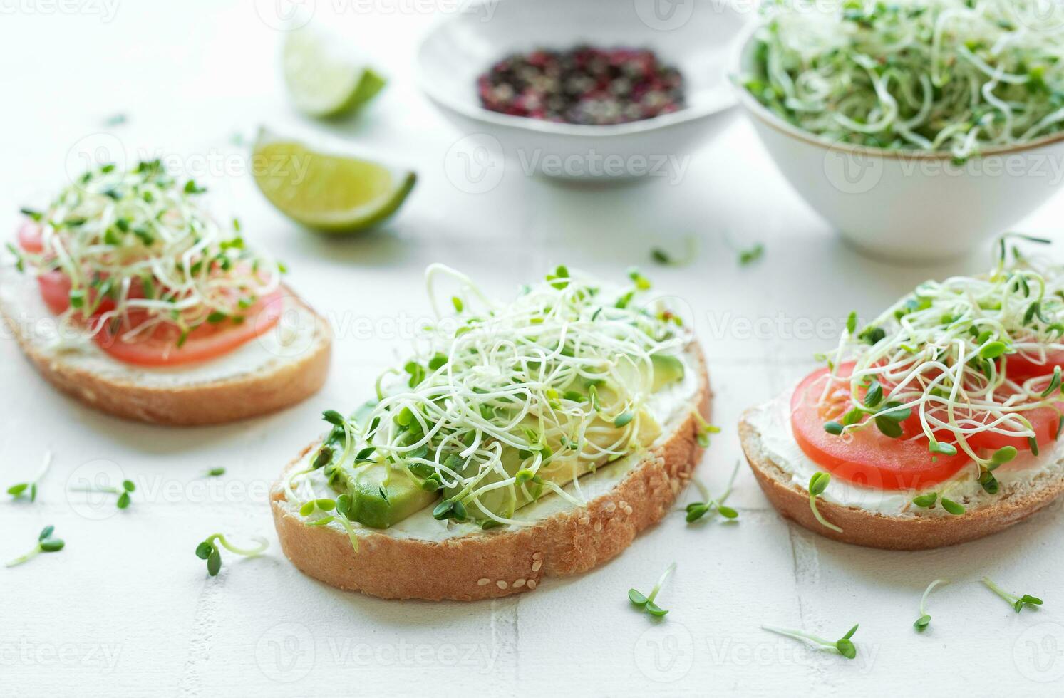Healthy Eating. Sandwiches with tomatoes, avocado and microgreens. photo