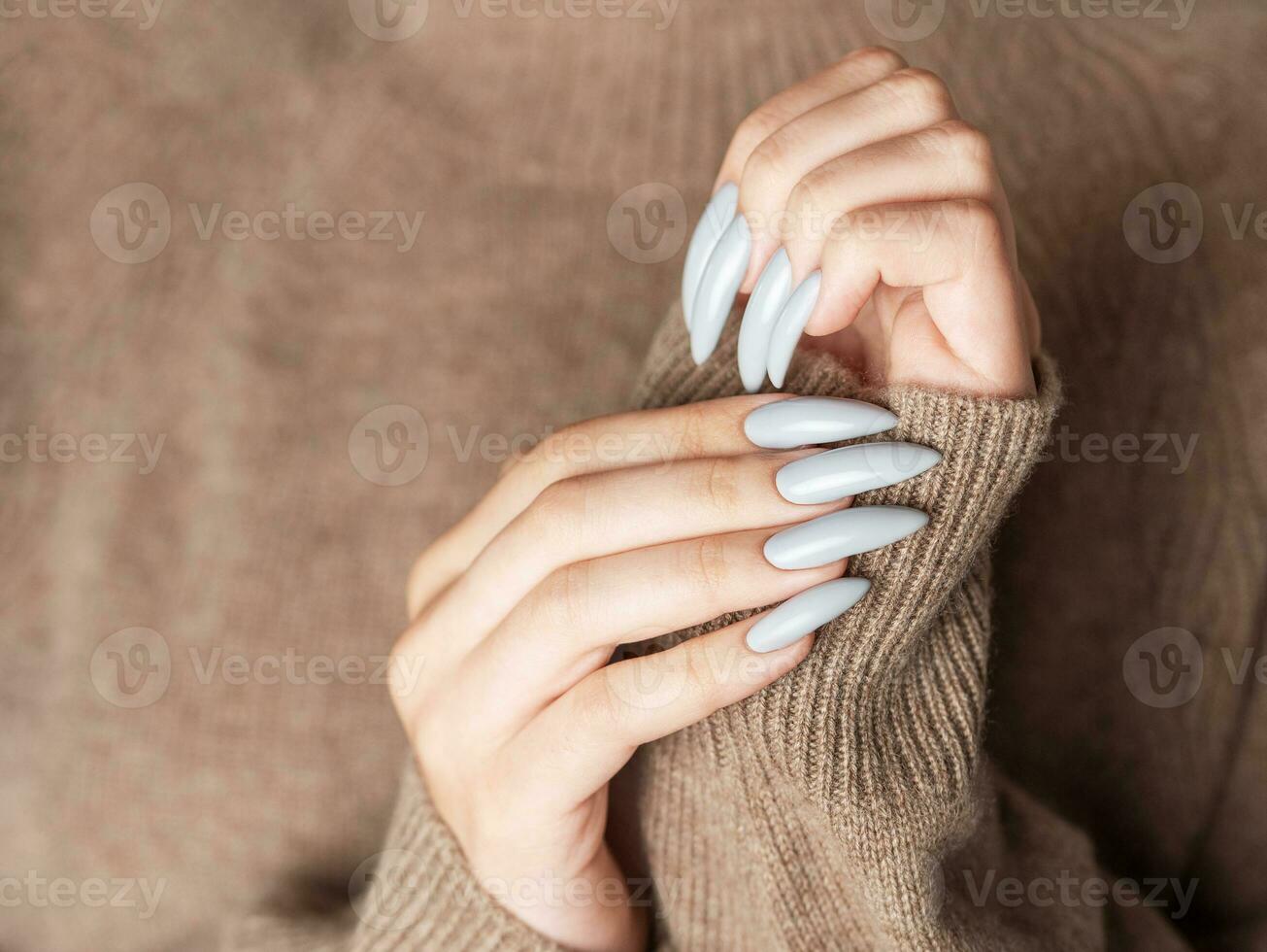 Woman's hand with grey nail polish photo