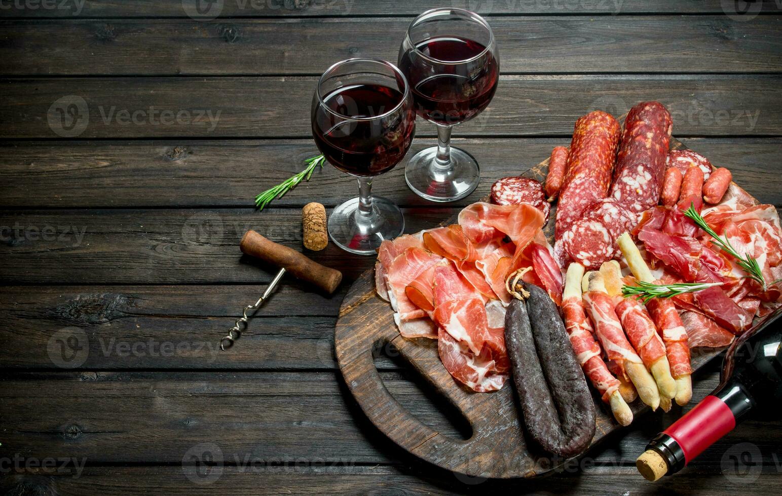 Antipasto background.Various assortment of meat snacks with red wine. photo