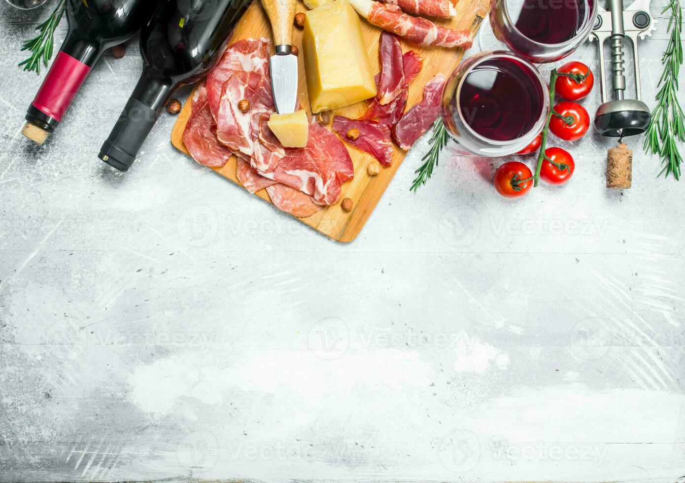 Antipasto background. Various meat and cheese snacks with red wine. photo
