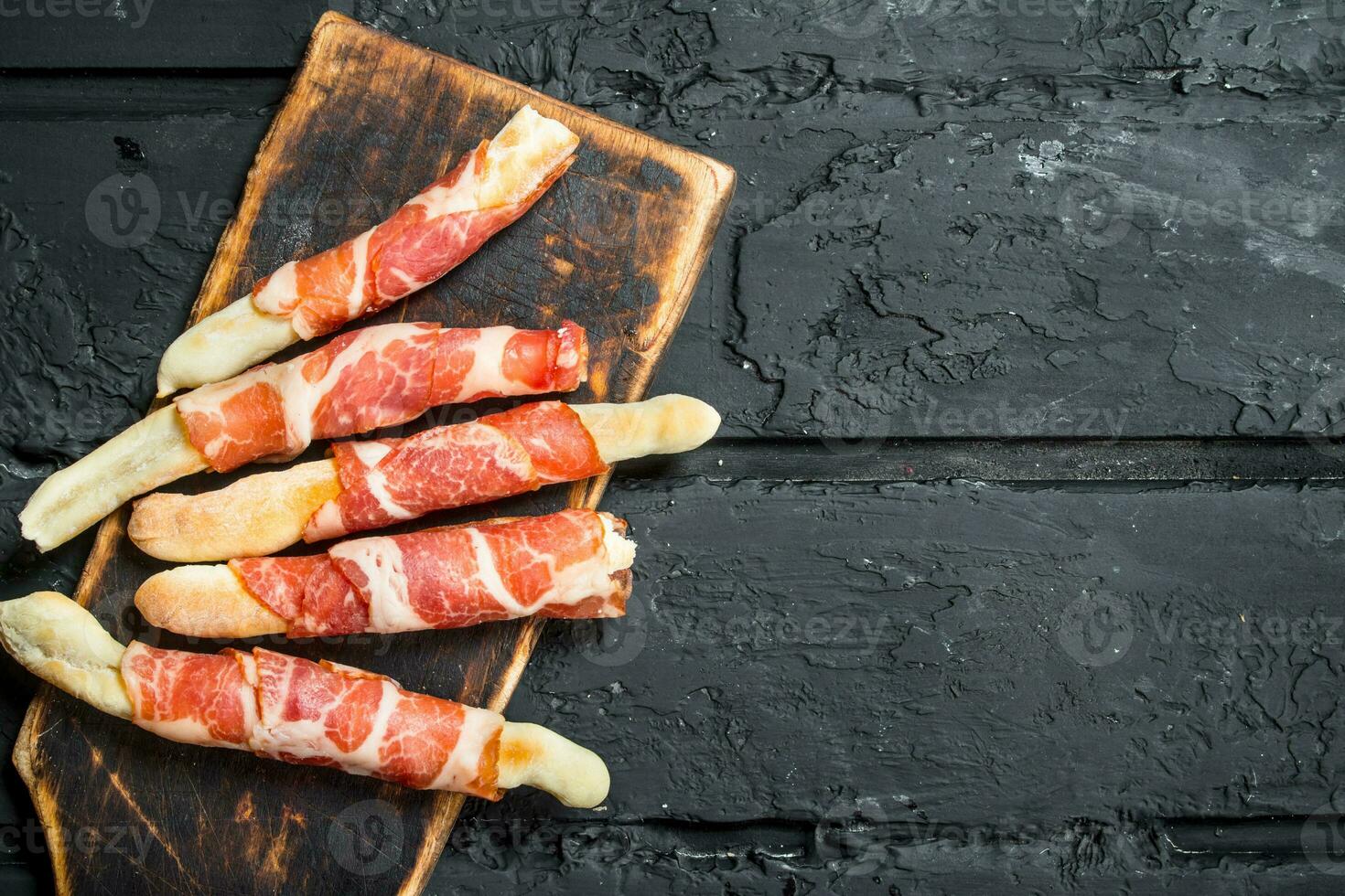 Antipasto background.Breadsticks with bacon. photo