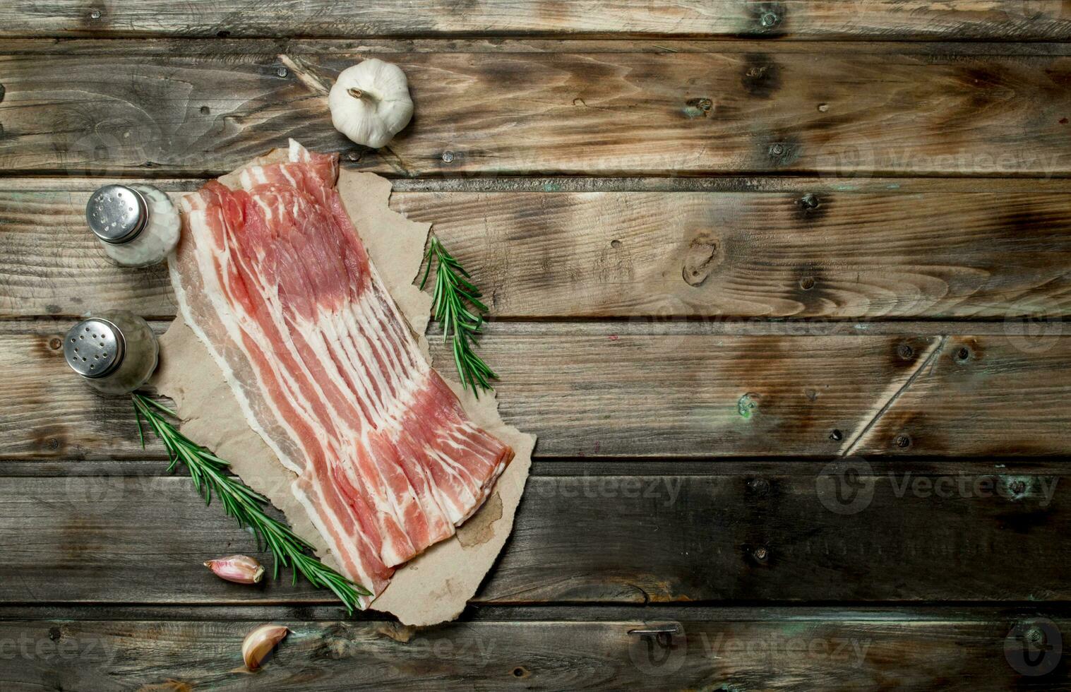 Raw bacon on paper. photo