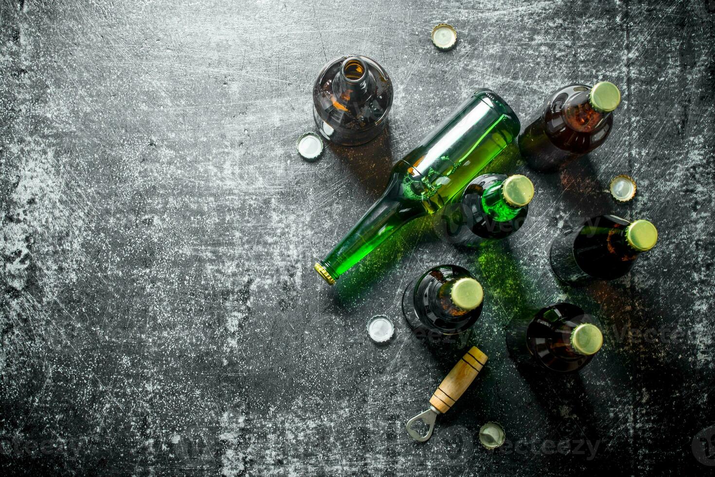 Beer bottles and a opener. photo