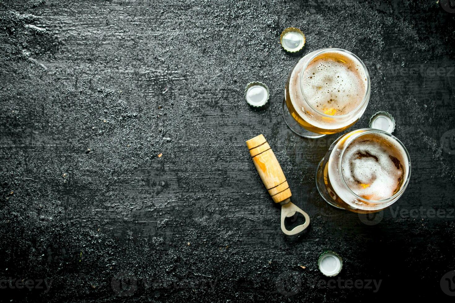 Glasses of beer and opener. photo